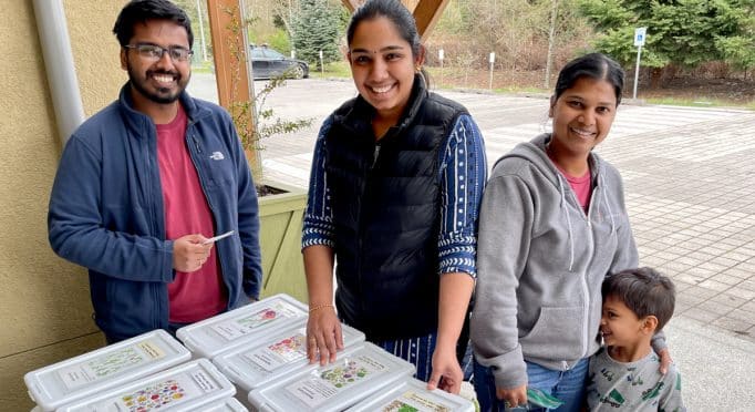 Gardeners look through the bins at the Sammamish Valley Alliance annual Seed Swap at 21 Acres.