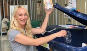 Kelly Rankich holds up a recyclable container at the 21 Acres waste stream.