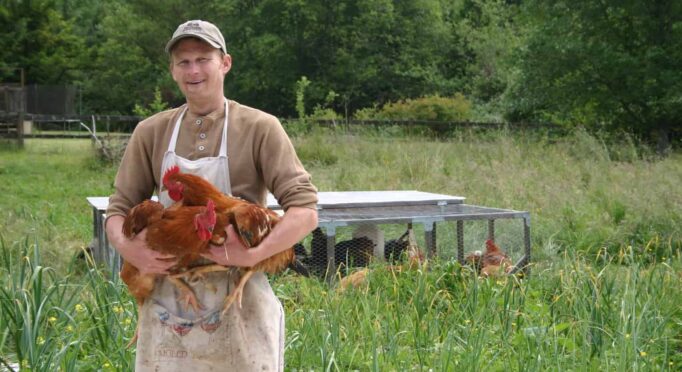 Daniel from Hawthorn Farm holds backyard raised chickens.