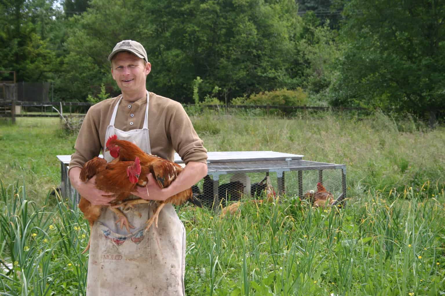 Daniel from Hawthorn Farm holds backyard raised chickens.