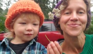 Dr. Sarah Sue Myers and her son Leo explore herbal remedies in the garden.