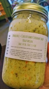 A jar of Kari Fetrow's Broccoli & Cauliflower Cheddar Soup made for the 21 Acres Farm Market.