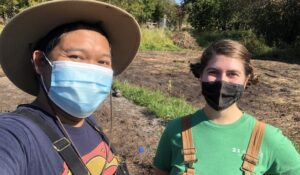 Volunteer Danno Tabing and staff member Angelica Lucchetto stop for a masked selfie during a sunny day in August.