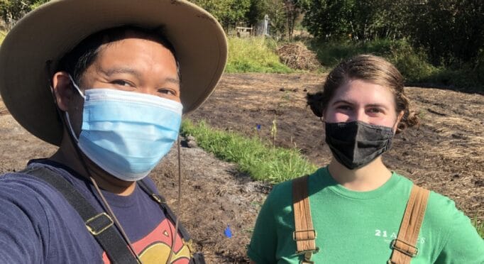 Volunteer Danno Tabing and staff member Angelica Lucchetto stop for a masked selfie during a sunny day in August.