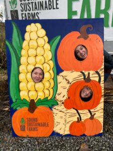 Hillary, Becca, and Liesl pose as vegetables at Sound Sustainable Farms.