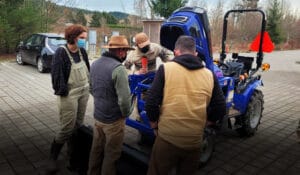 Farmers of the Sustainable Ag Tool Share in the Sammamish Valley inspect the new Solectrac electric tractor.