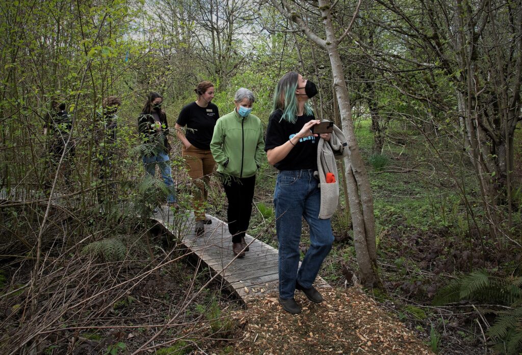 Ansley leads a group through the wetland on a farm tour