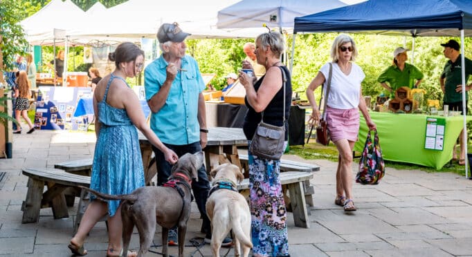 Shoppers and visitors enjoy a popup market on the 21 Acres Farm Market patio.