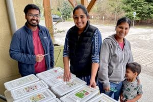 Gardeners look through the bins at the Sammamish Valley Alliance annual Seed Swap at 21 Acres.
