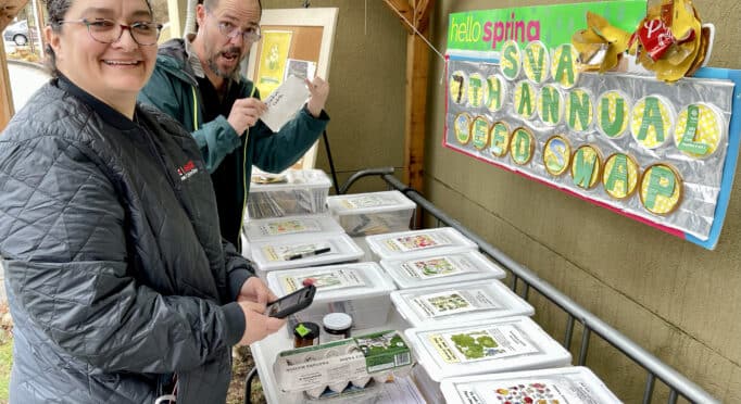 Gardeners look through seed packets at the annual SVA Seed Swap held at 21 Acres.