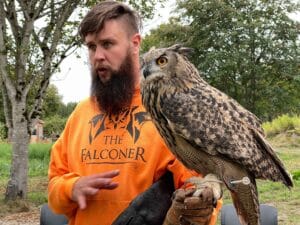 John the Falconer give an educational presentation with his Eurasian Eagle Owl at 21 Acres.