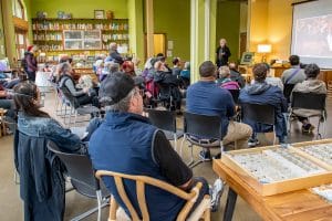 A lecture taking place in the larger meeting room at 21 Acres.