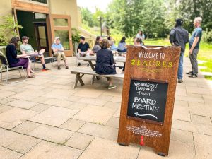 A Board meeting takes place on the 21 Acres patio.