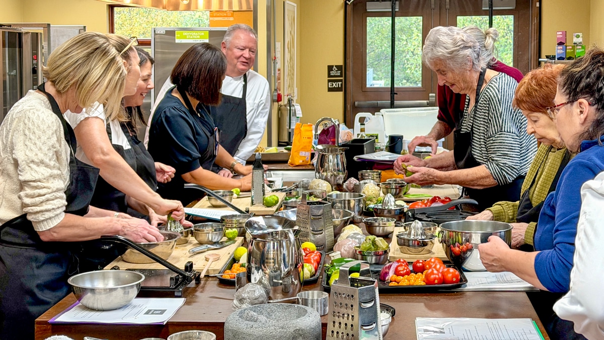 Ron Askew teaches a cooking class on how to make masa tortillas in the 21 Acres kitchen.