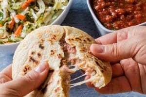 Photo of a Salvadoran pupusa, slaw and salsa.