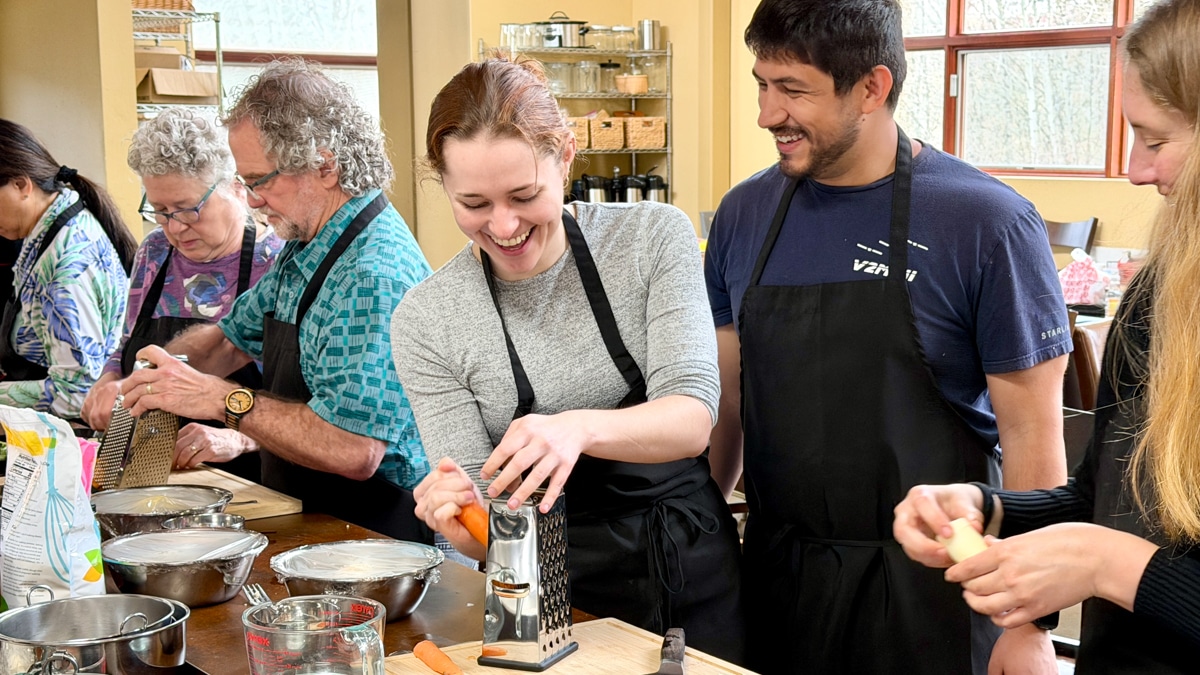 Cooking class students enjoy a laugh in the 21 Acres kitchen.